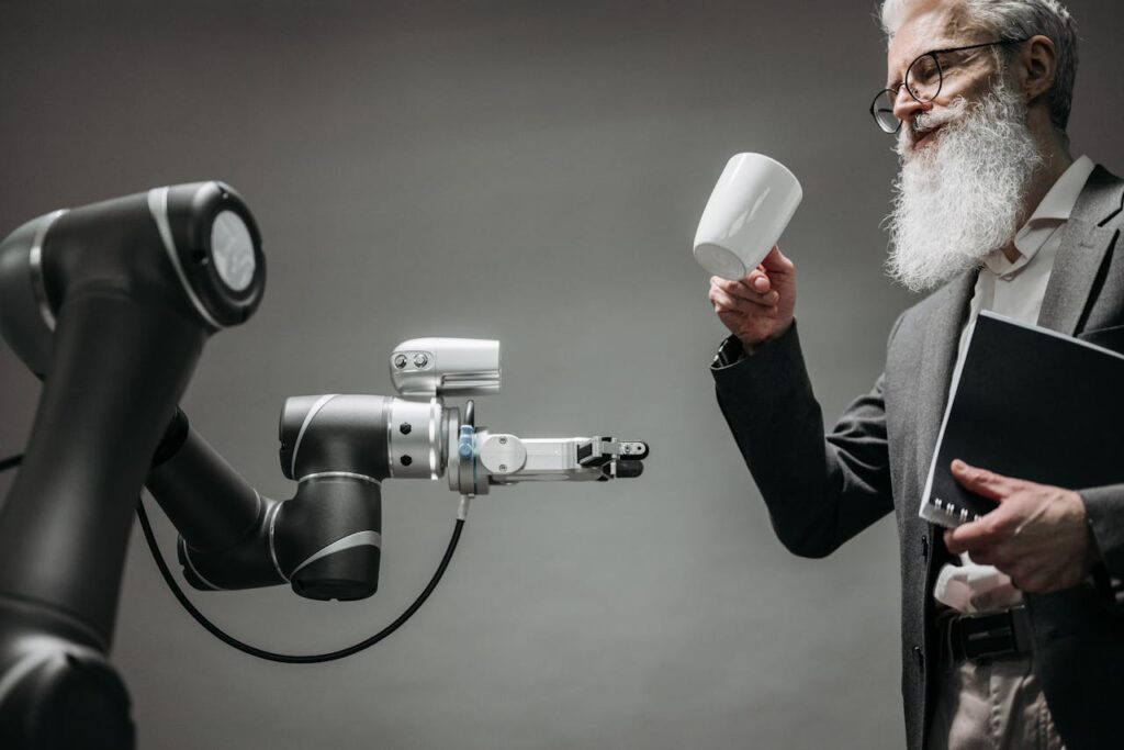 A Bearded Man Holding a Cup Near a Robot